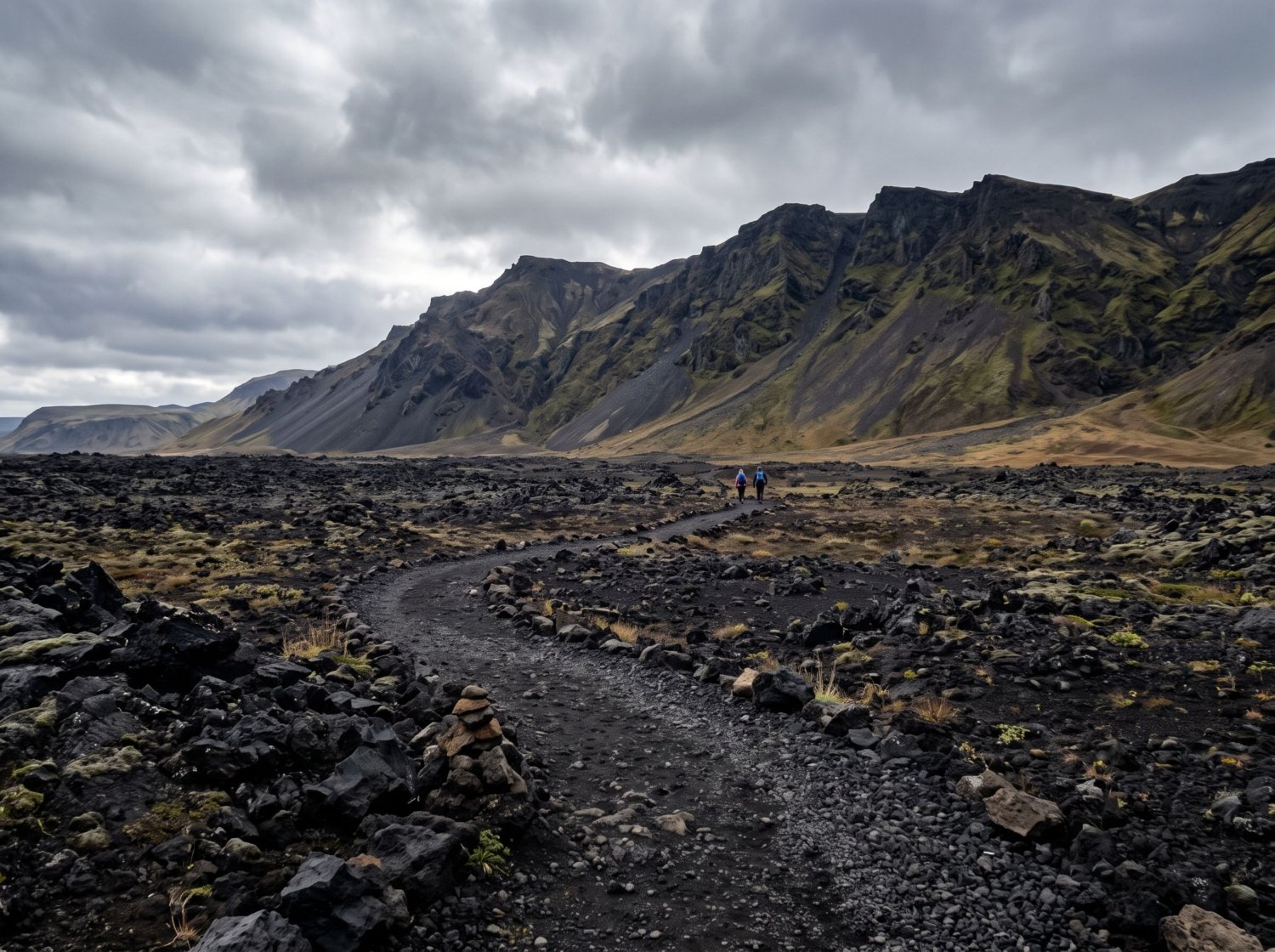 A marked gravel hiking trail crossing a young black lava field in Iceland